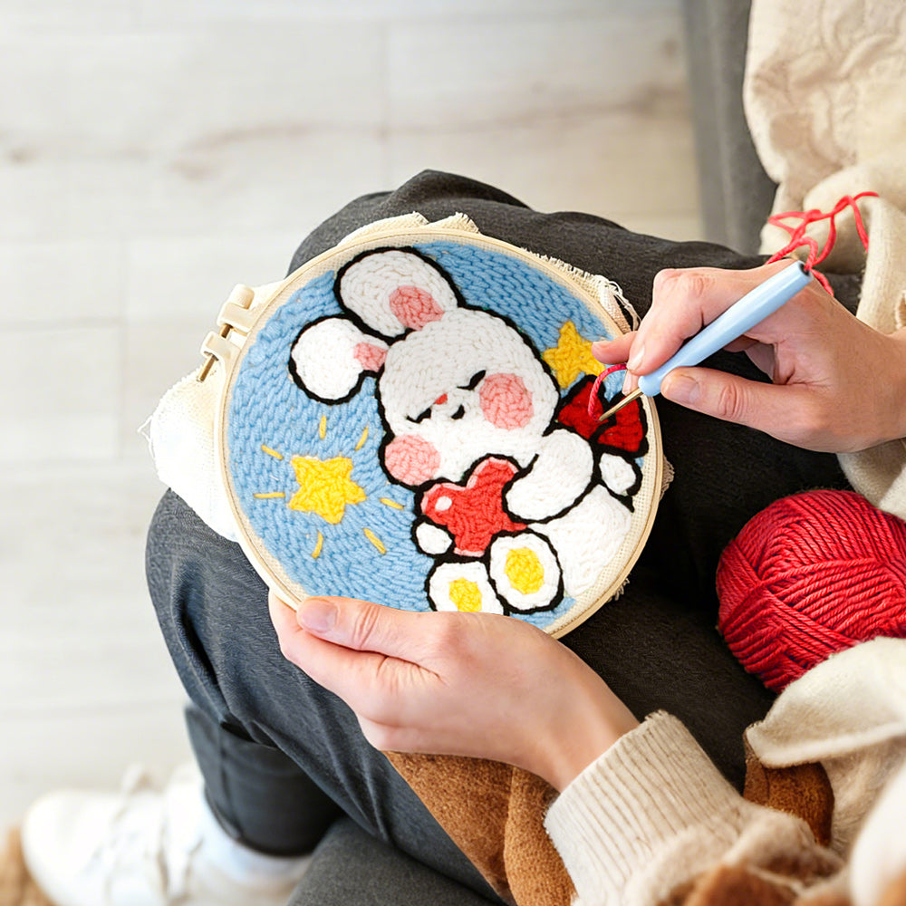Creating handmade cute bunny holding hear punch needle artwork