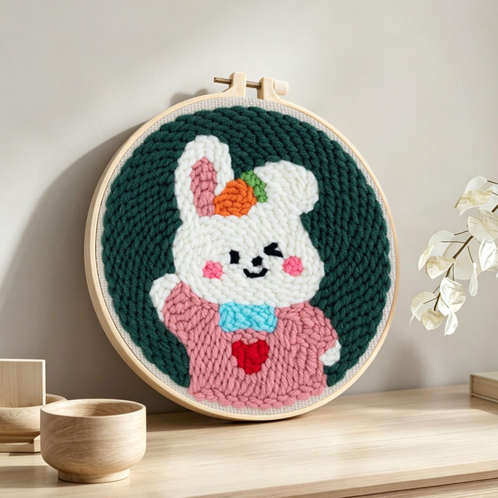 Cute bunny in pink outfit punch needle artwork displayed on a table