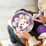 Creating handmade cute bunny with blue bow punch needle artwork