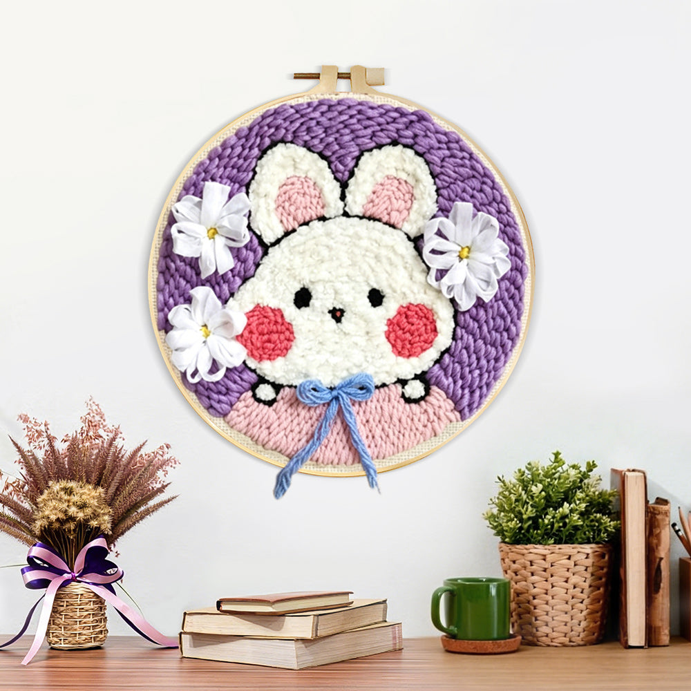 Finished cute bunny with blue bow artwork displayed on a wall