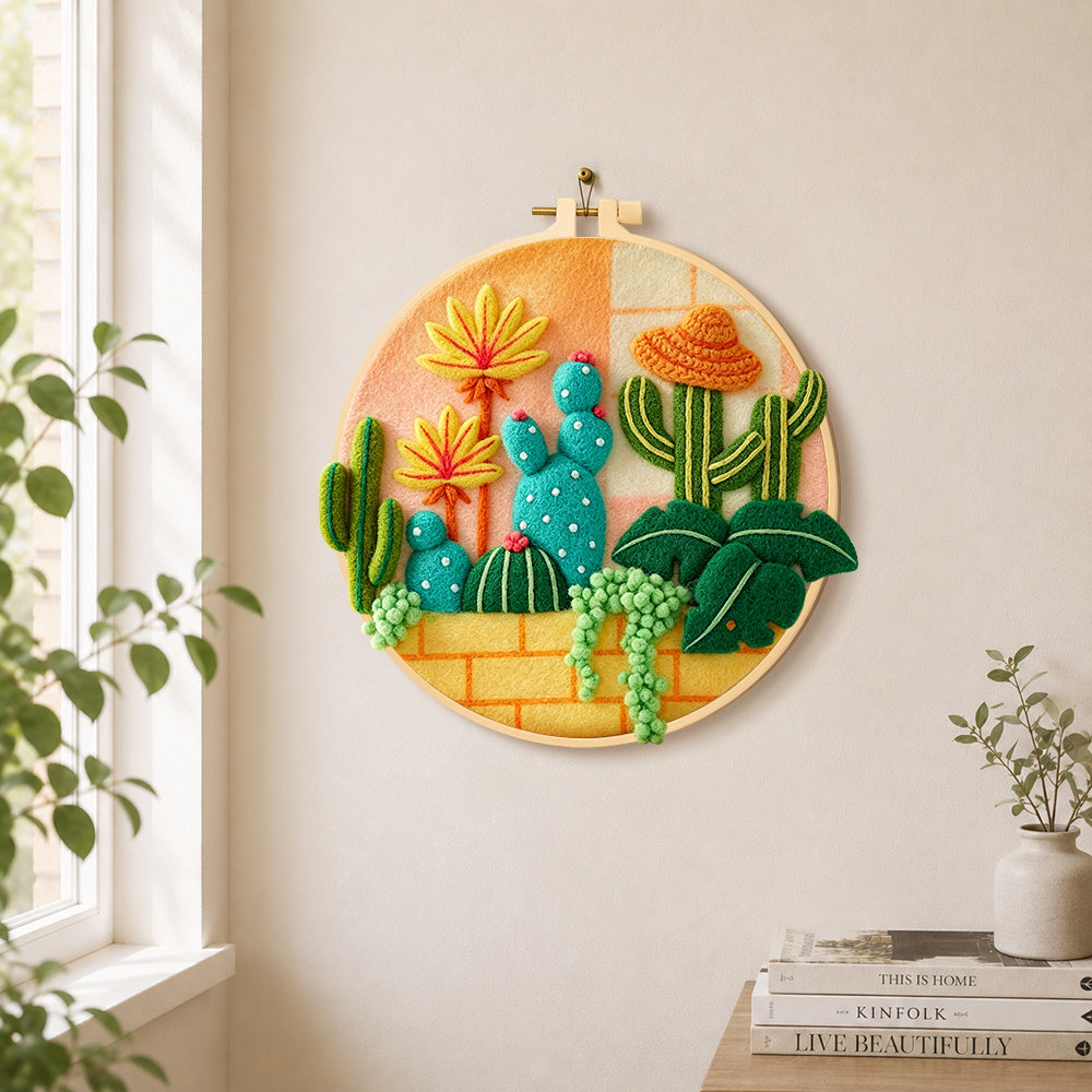 Cute cacti with sombrero hat needle felt wall art displayed in a bright home interior