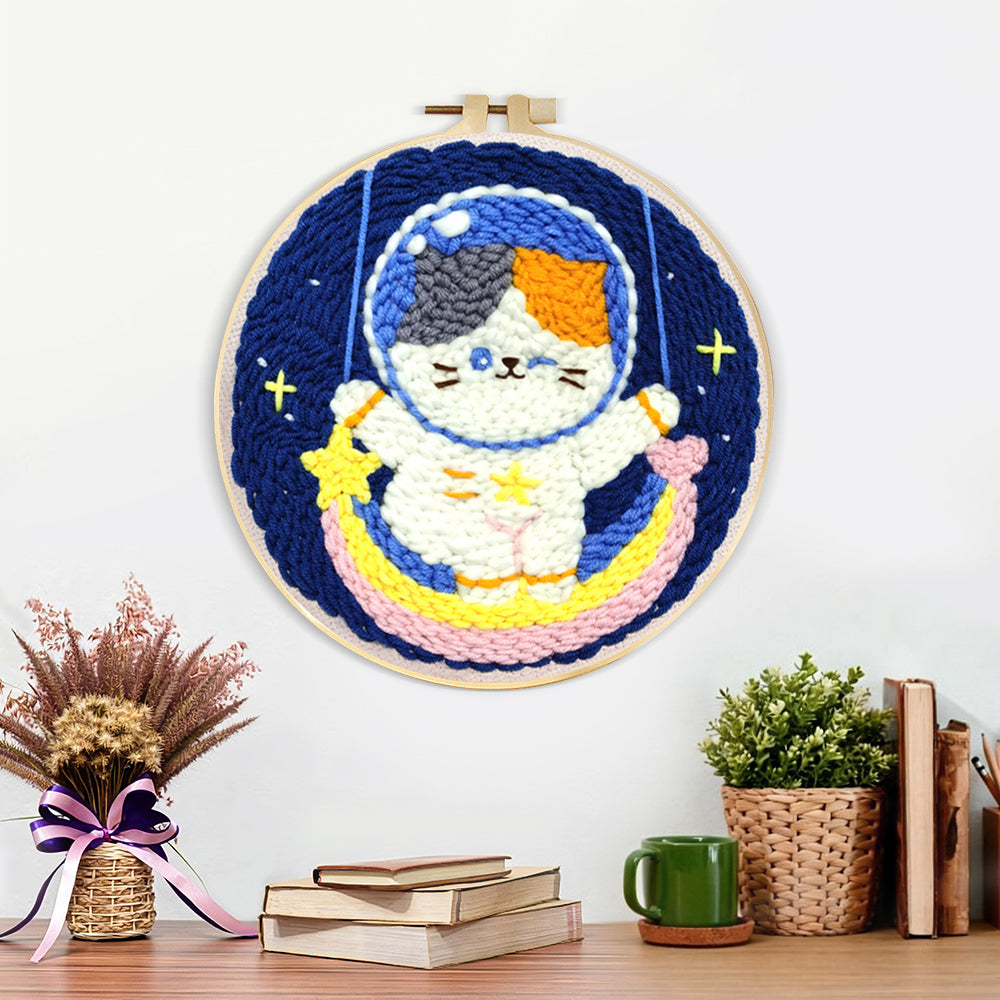 Finished cute calico cat astronaut on rainbow moon artwork displayed on a wall
