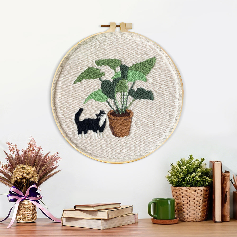 Finished cute cat by houseplant artwork displayed on a wall