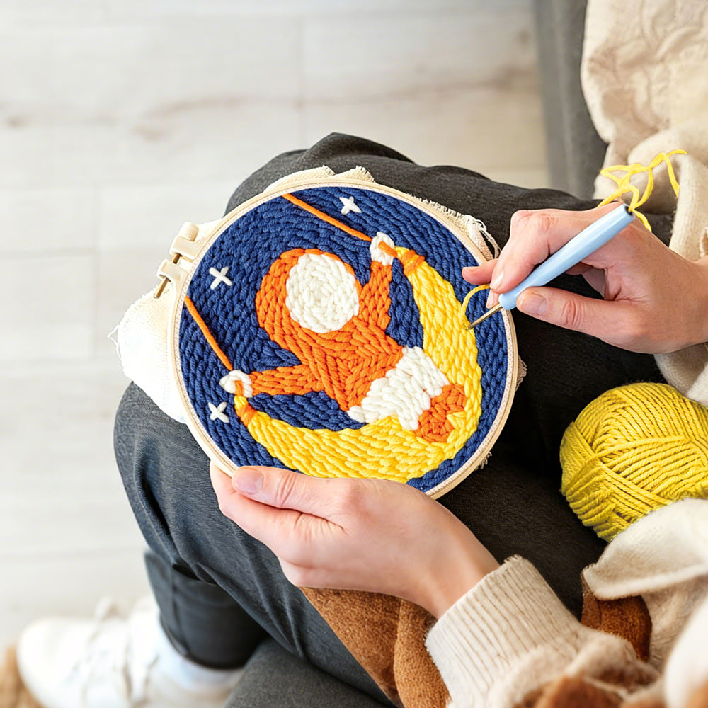 Creating handmade cute child on a moon swing punch needle artwork