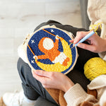 Creating handmade cute child on a moon swing punch needle artwork