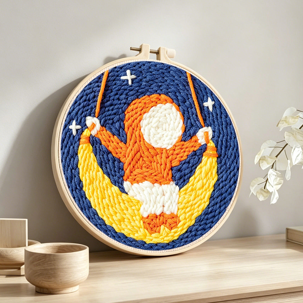 Cute child on a moon swing punch needle artwork displayed on a table