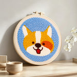 Cute corgi punch needle artwork displayed on a table
