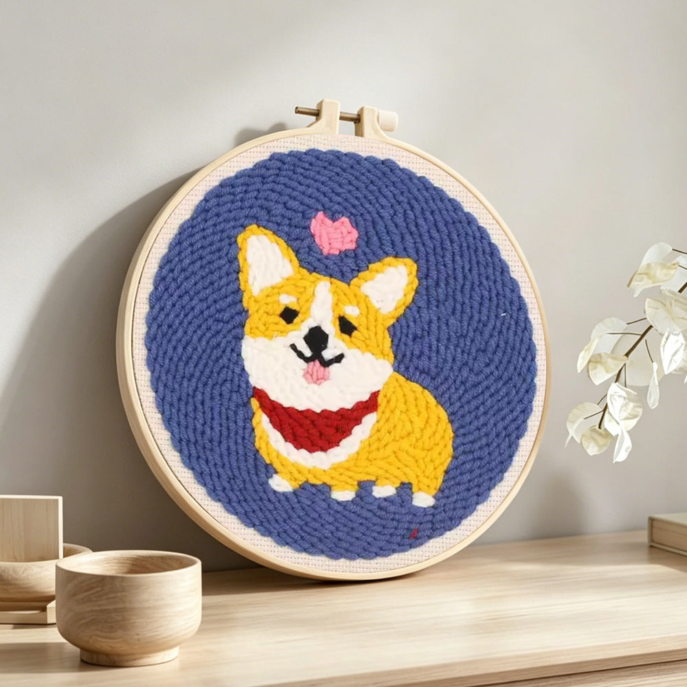 Cute corgi with heart punch needle artwork displayed on a table