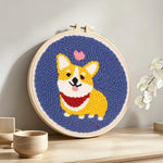 Cute corgi with heart punch needle artwork displayed on a table