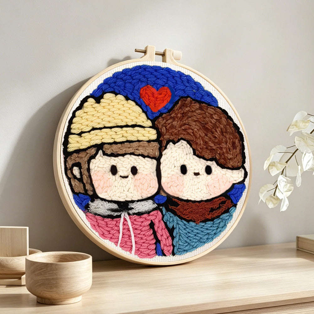 Cute couple portrait with heart punch needle artwork displayed on a table