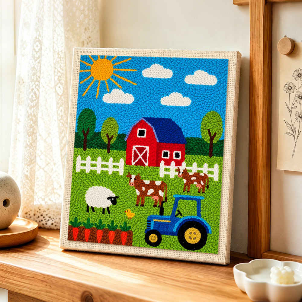 Cute farmyard animals and tractor punch needle artwork displayed on a table