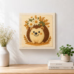 Finished cute floral crown hedgehog artwork displayed on a wall