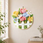 Cute flower bed with white picket fence needle felt wall art displayed in a bright home interior