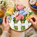 Creating the cute flower bed with white picket fence wool painting by hand with a felting needle