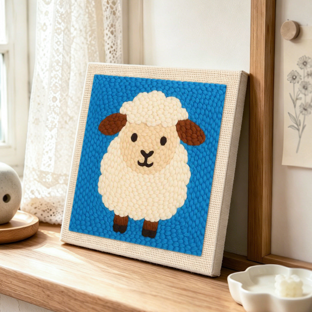 Cute fluffy sheep punch needle artwork displayed on a table