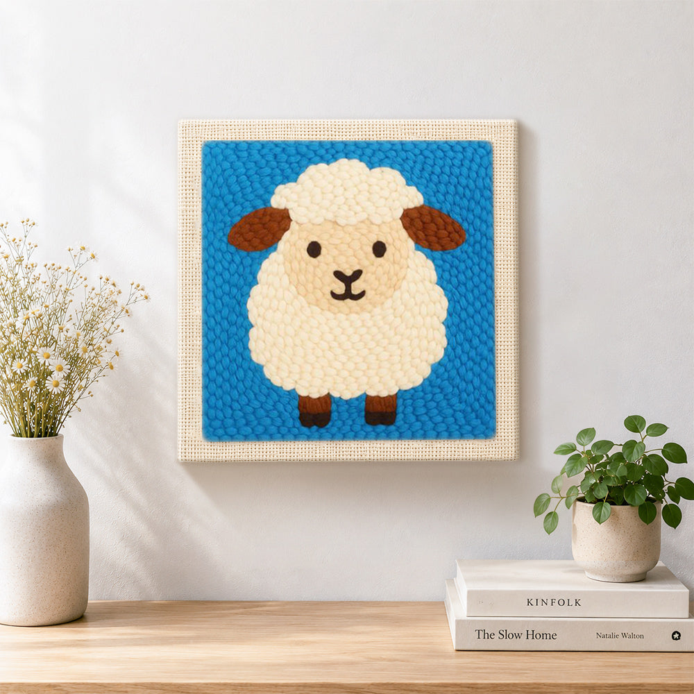 Finished cute fluffy sheep artwork displayed on a wall