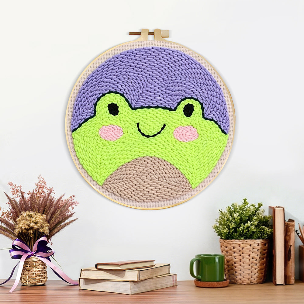 Finished cute frog face artwork displayed on a wall