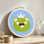 Cute frog with crown punch needle artwork displayed on a table