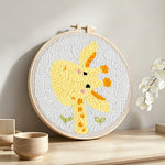 Cute giraffe punch needle artwork displayed on a table