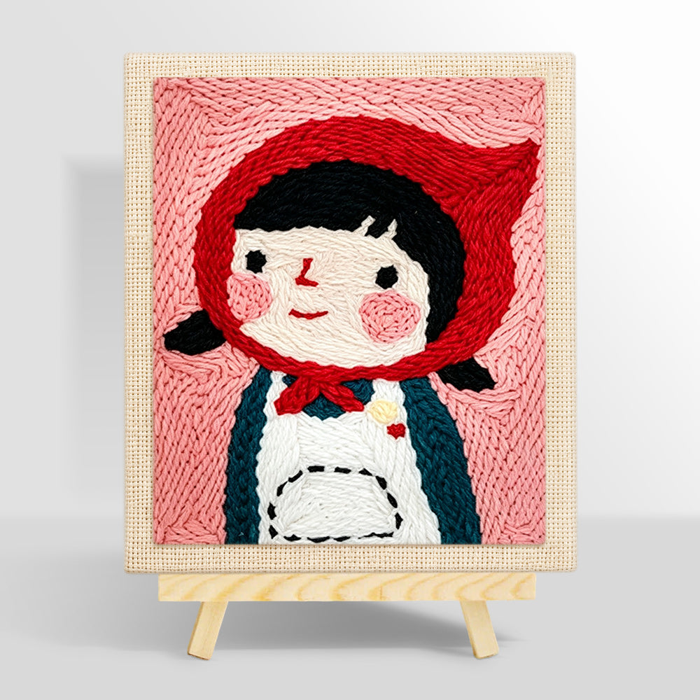 Cute girl in red headscarf punch needle kit for beginners