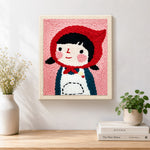 Finished cute girl in red headscarf artwork displayed on a wall