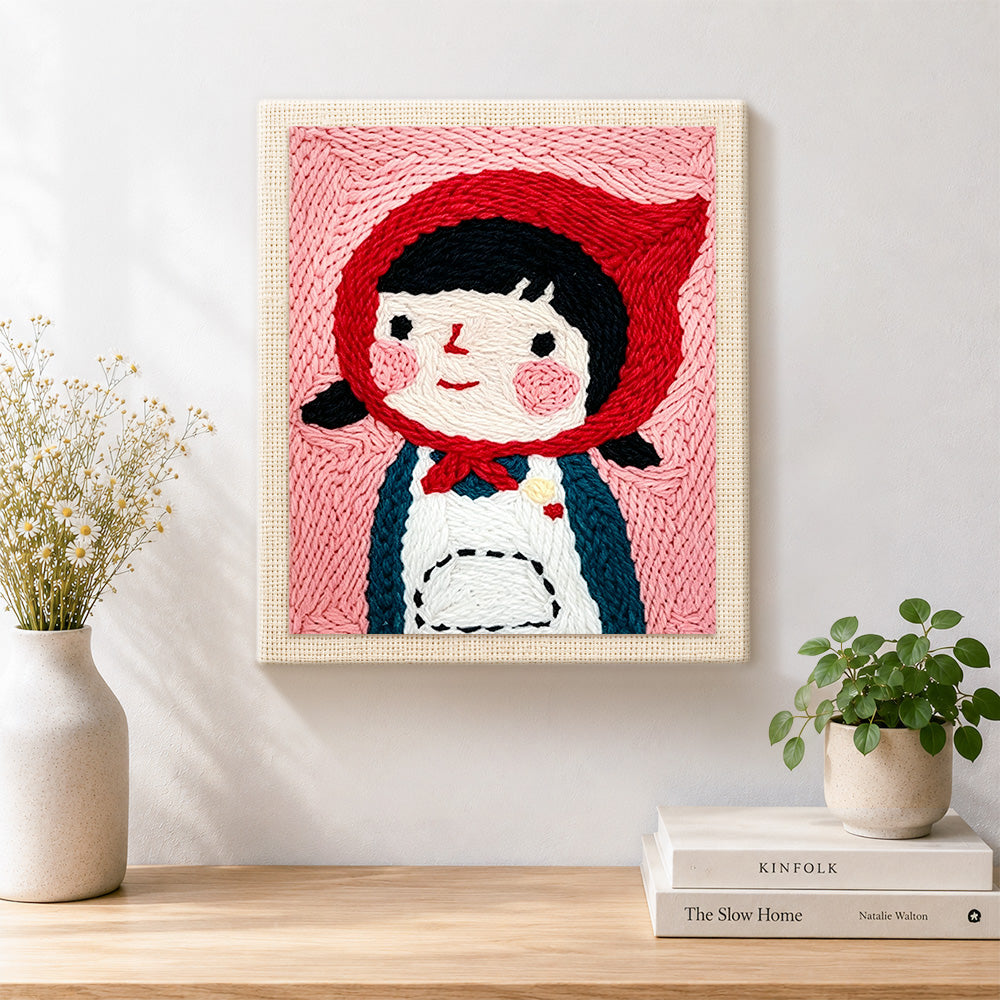 Finished cute girl in red headscarf artwork displayed on a wall