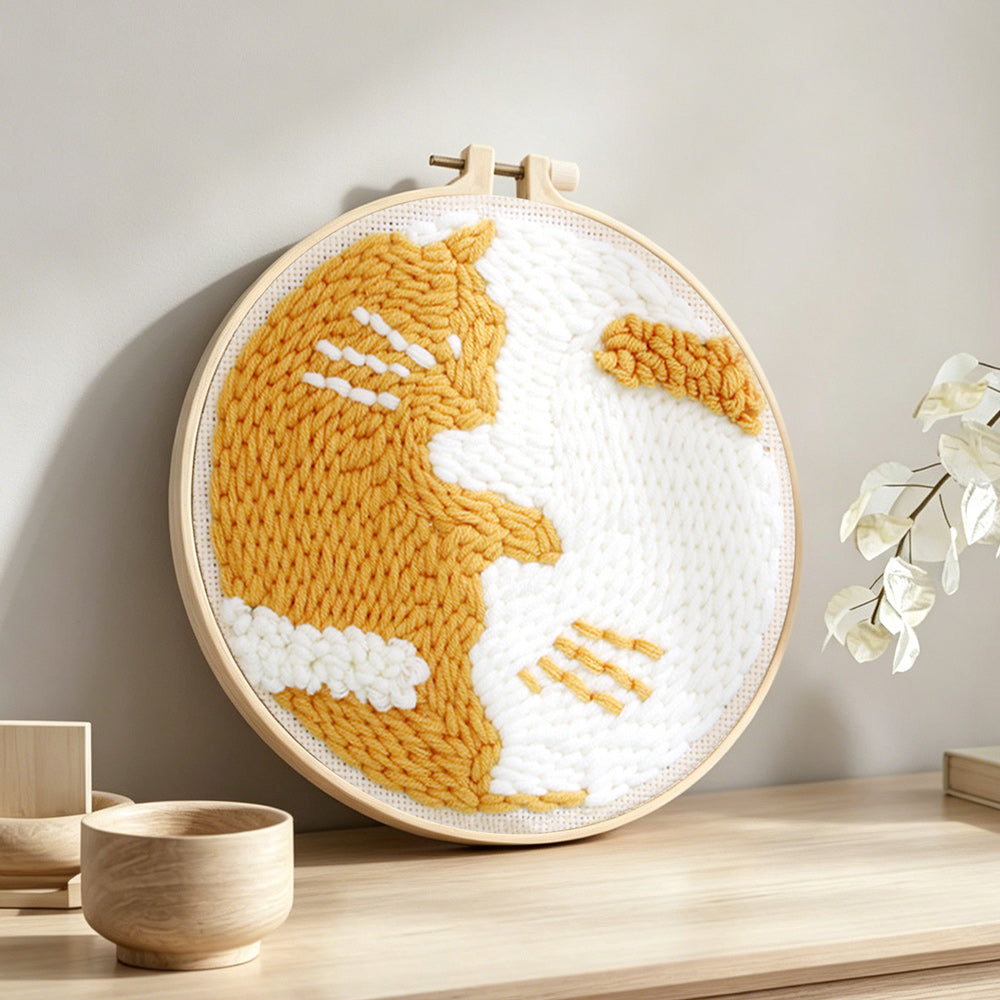 Cute golden cat punch needle artwork displayed on a table