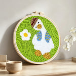 Cute goose with daisy punch needle artwork displayed on a table