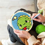Creating handmade cute green baby dinosaur punch needle artwork