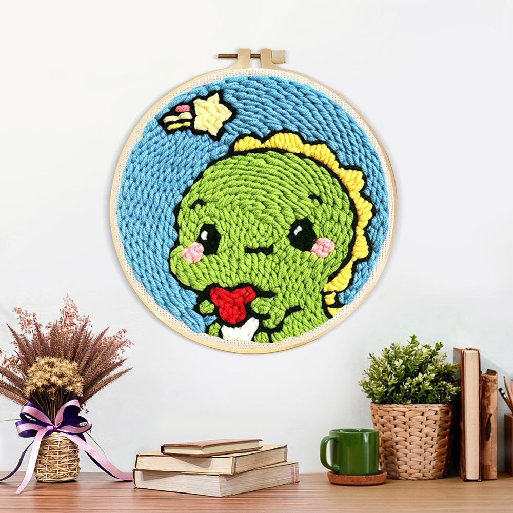 Finished cute green baby dinosaur artwork displayed on a wall