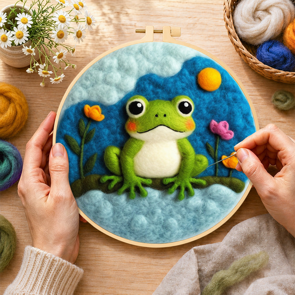 Creating the cute green frog under the cloud wool painting by hand with a felting needle