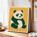 Cute green panda punch needle artwork displayed on a table