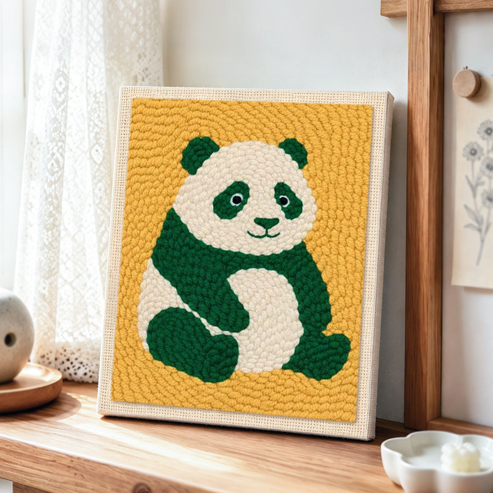 Cute green panda punch needle artwork displayed on a table