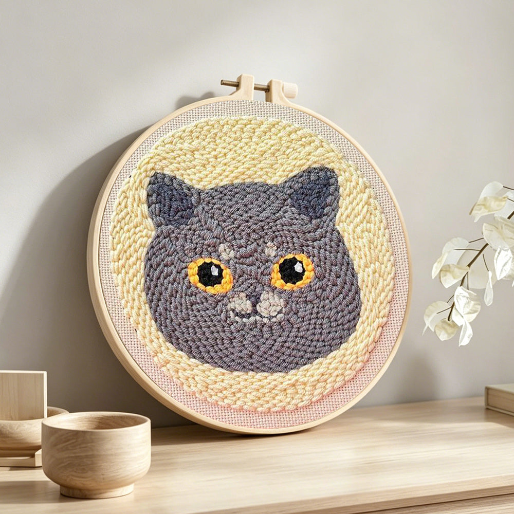 Cute grey cat punch needle artwork displayed on a table