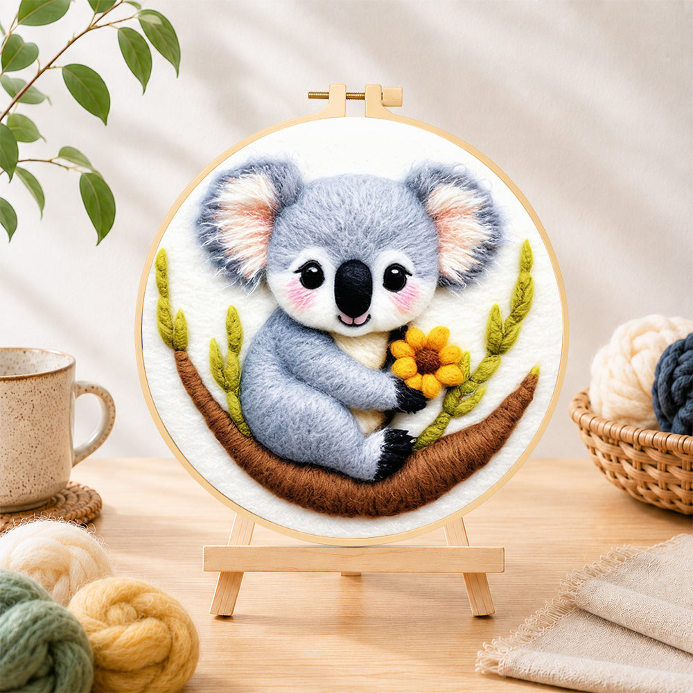 Finished cute koala holding a flower needle felting displayed on a wooden easel