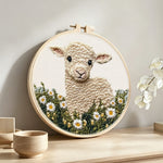 Cute lamb in daisy field punch needle artwork displayed on a table