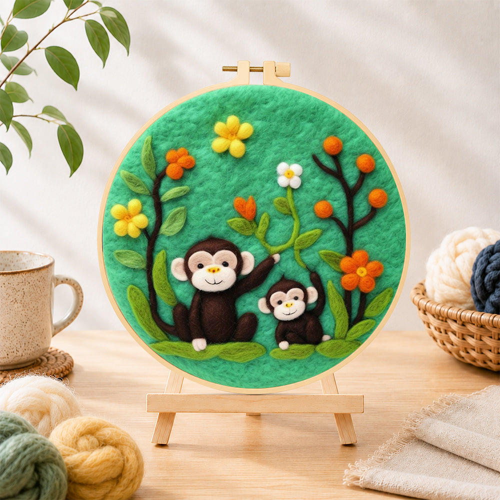 Finished cute monkey and baby needle felting displayed on a wooden easel
