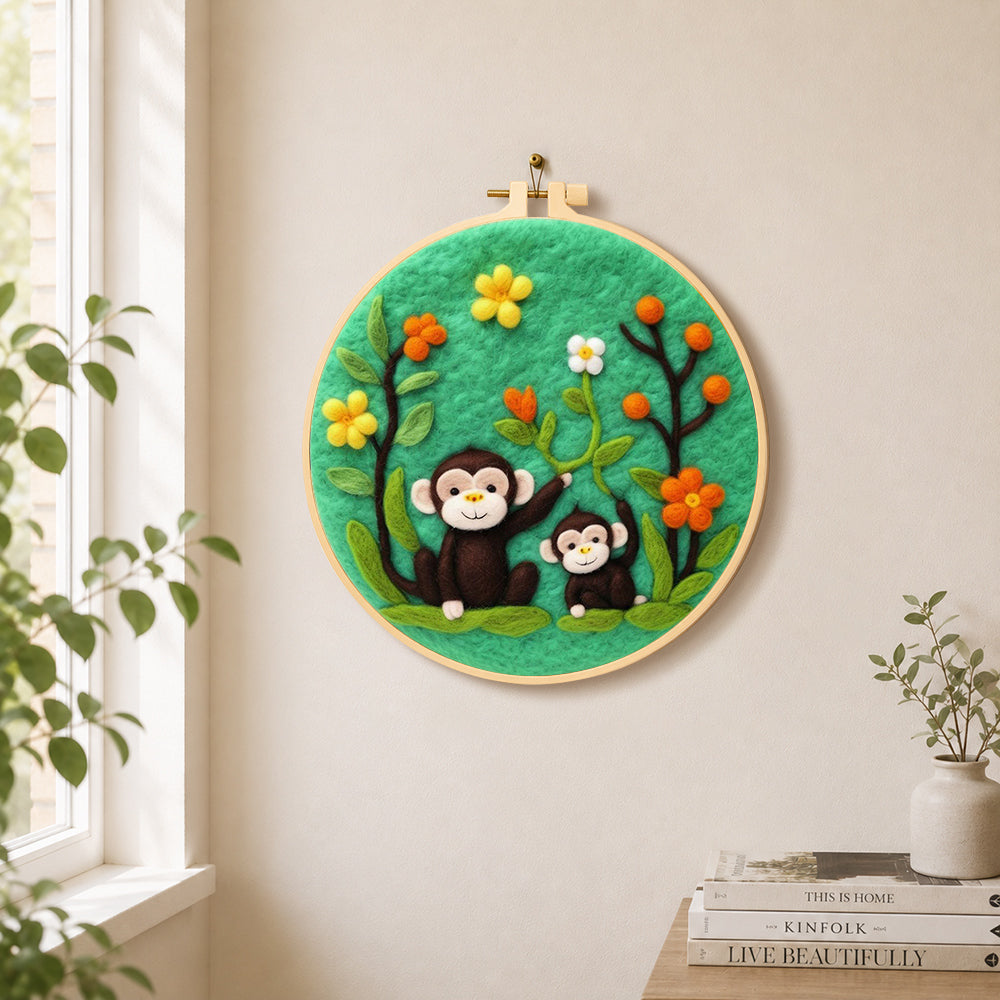 Cute monkey and baby needle felt wall art displayed in a bright home interior