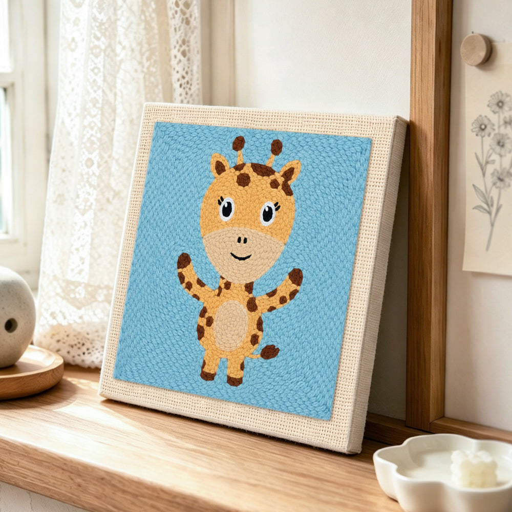 Cute open-arms giraffe punch needle artwork displayed on a table