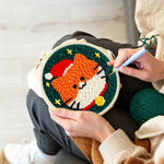 Creating handmade cute orange cat in santa hat punch needle artwork