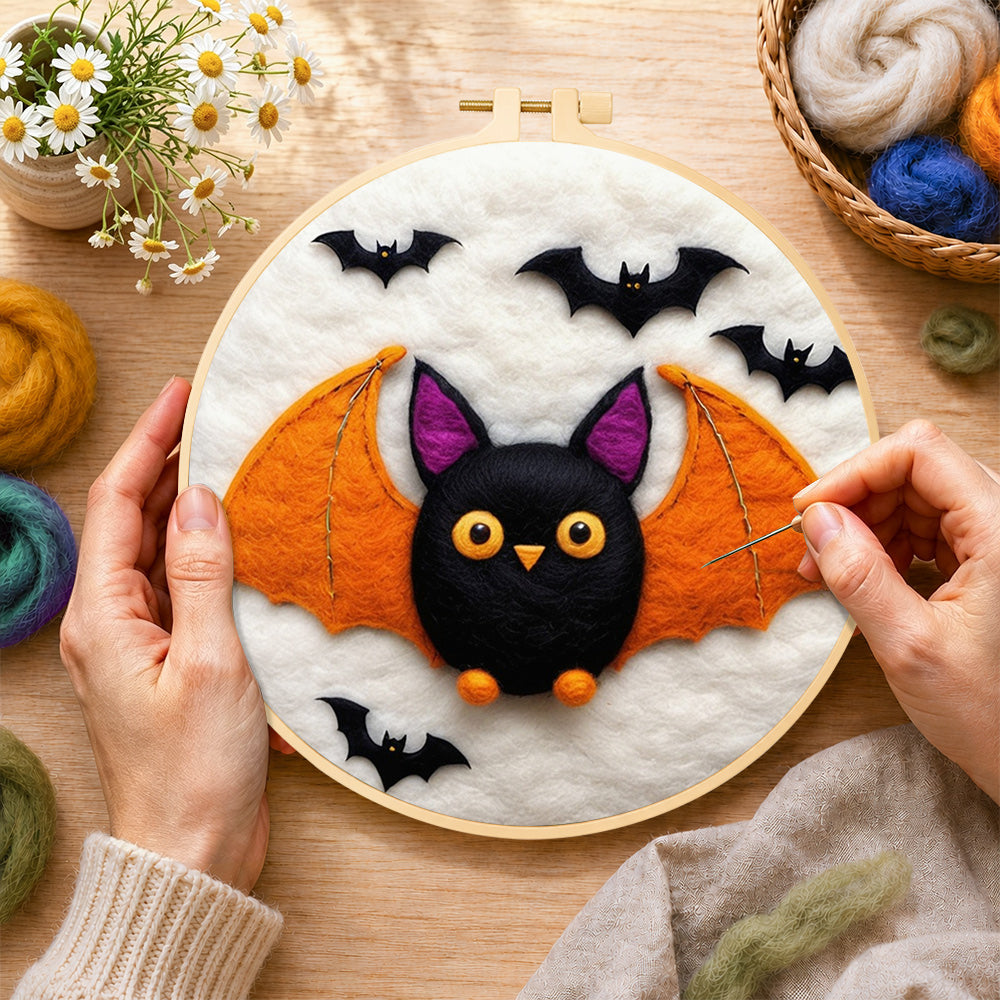 Creating the cute orange-winged bat wool painting by hand with a felting needle