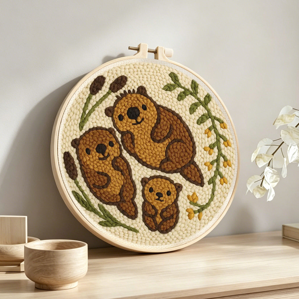 Cute otter family punch needle artwork displayed on a table