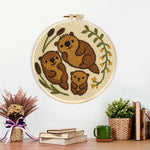 Finished cute otter family artwork displayed on a wall
