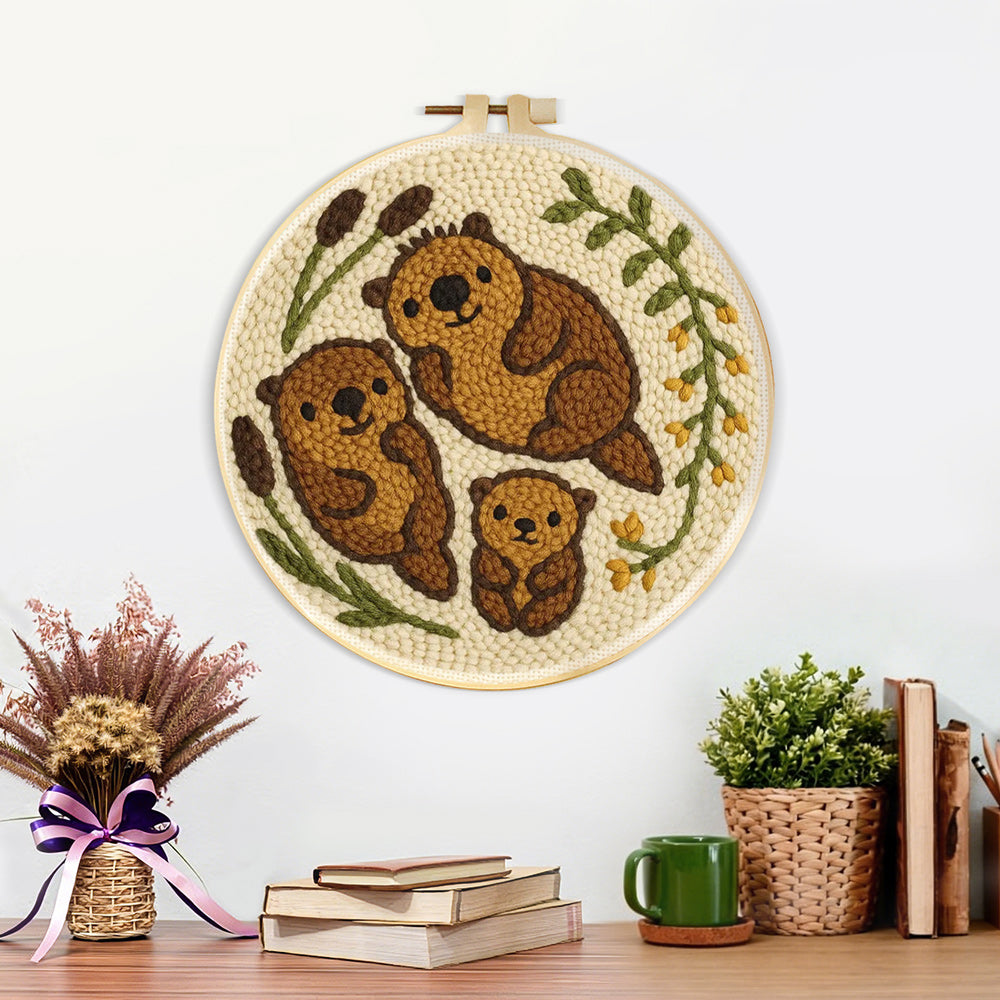 Finished cute otter family artwork displayed on a wall