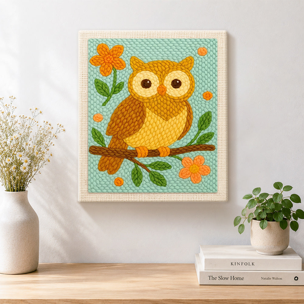 Finished cute owl on branch artwork displayed on a wall