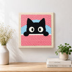 Finished cute peeking kitten artwork displayed on a wall
