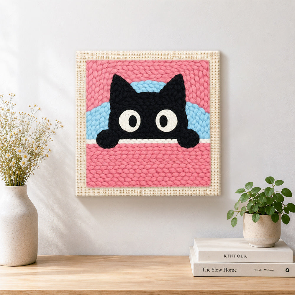 Finished cute peeking kitten artwork displayed on a wall