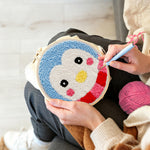 Creating handmade cute penguin face punch needle artwork