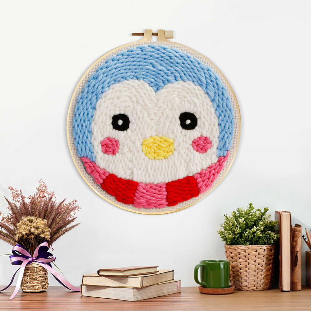 Finished cute penguin face artwork displayed on a wall