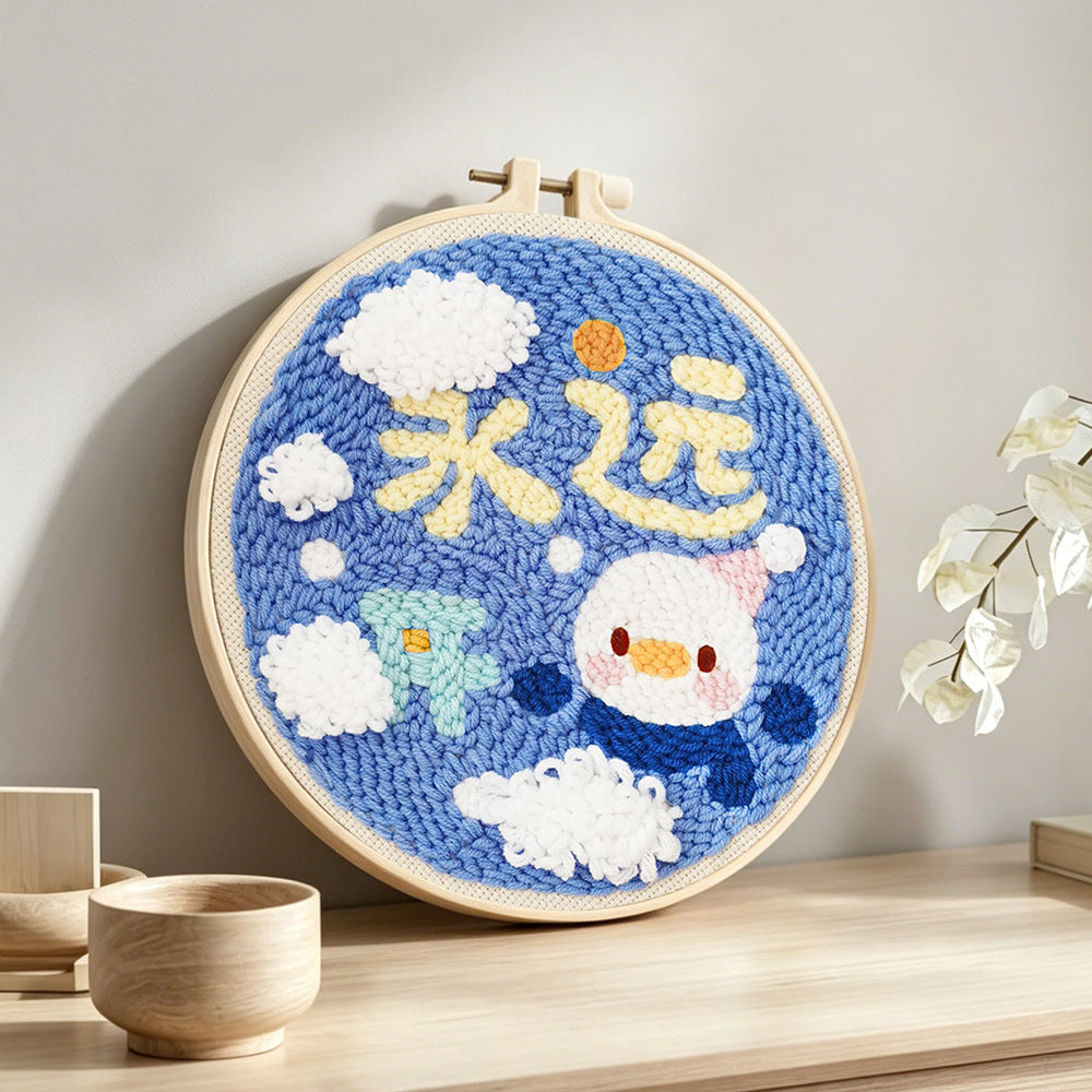 Cute penguin with "always happy" text punch needle artwork displayed on a table